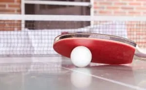 White ball under a red paddle rubber grip